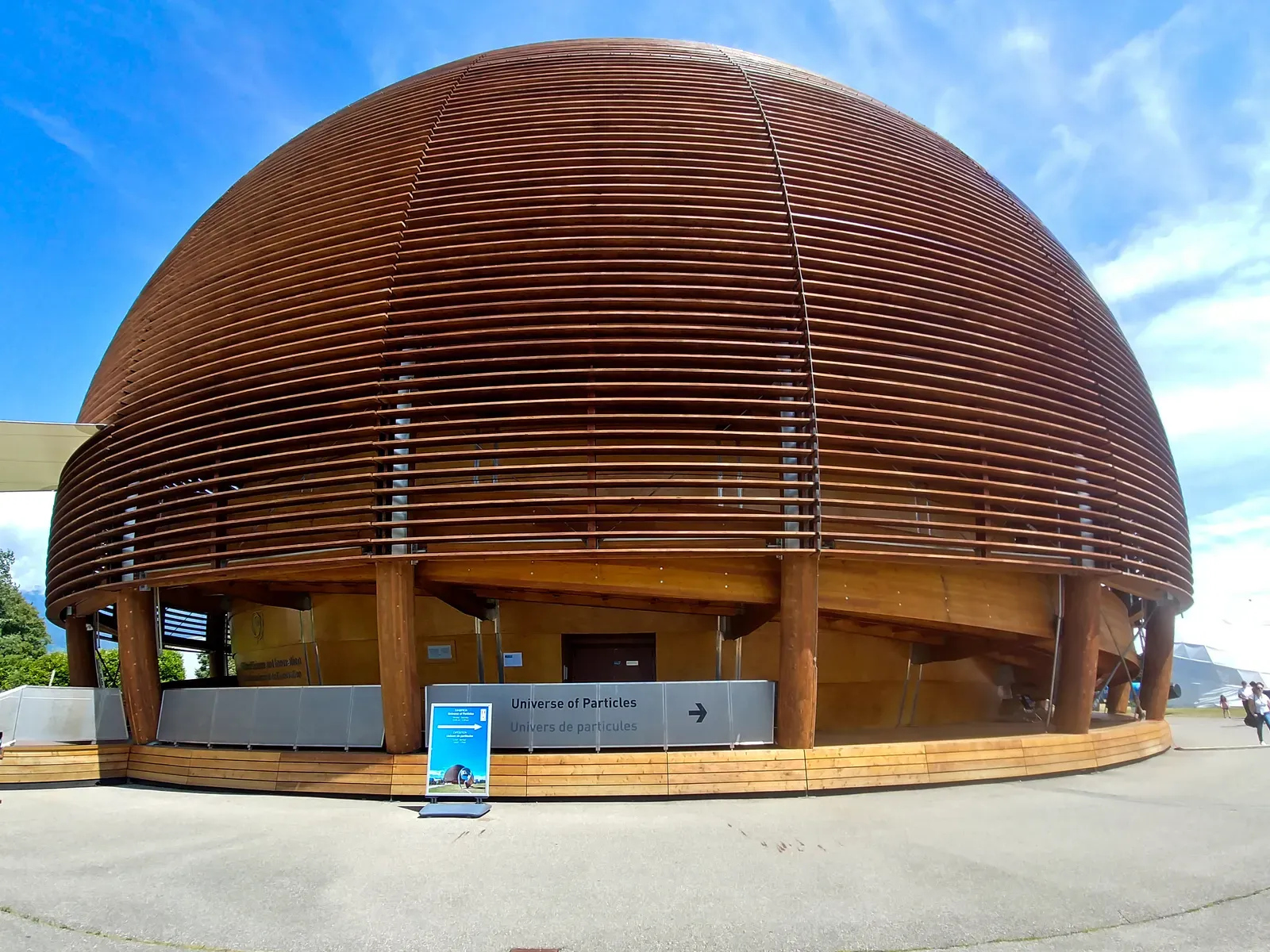 The wooden dome of the Globe of Science and Innovation against a blue sky.