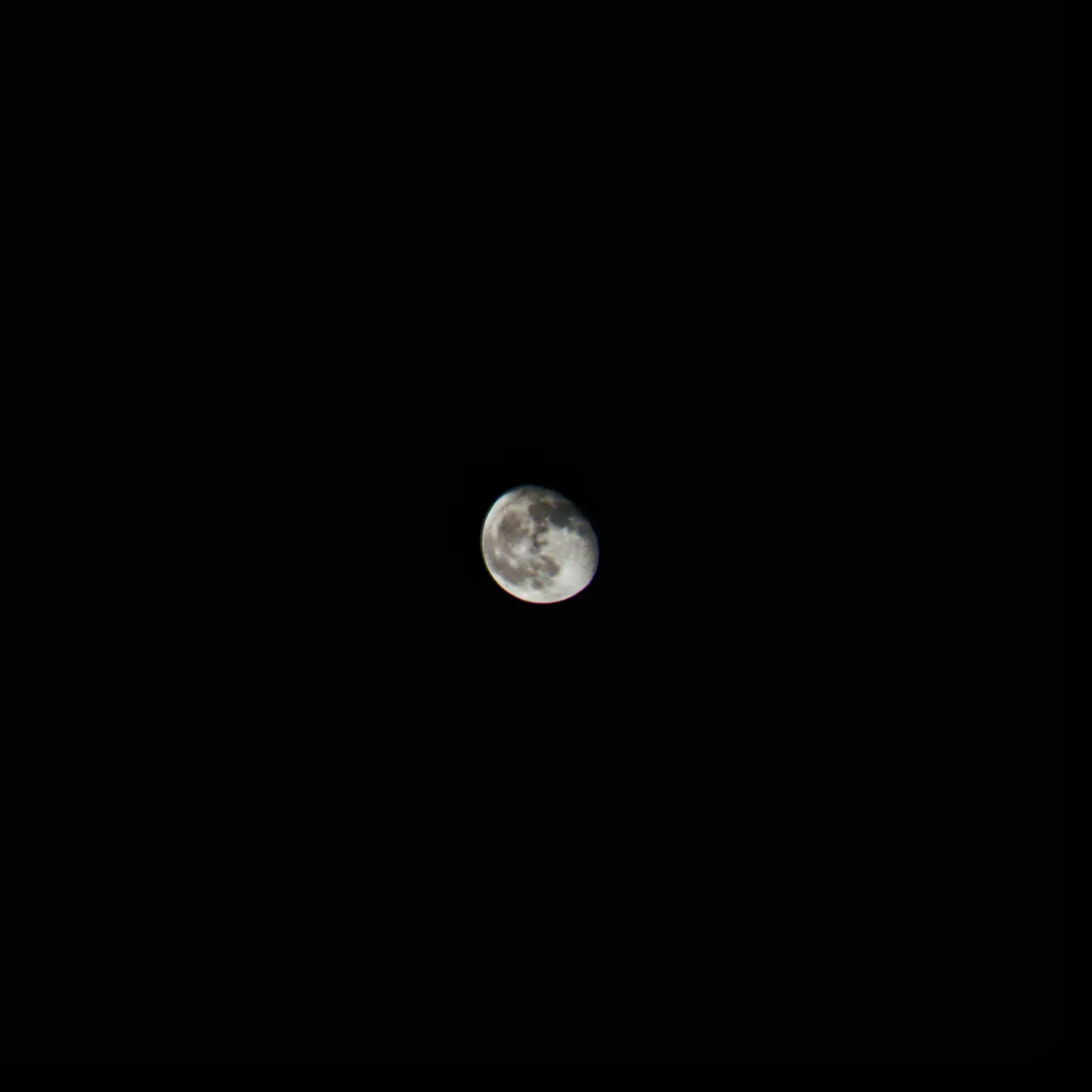 A waning gibbous moon, photographed handheld on a phone.